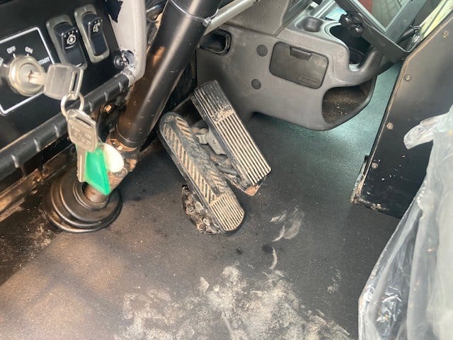 Driver's side with pedals as focus.